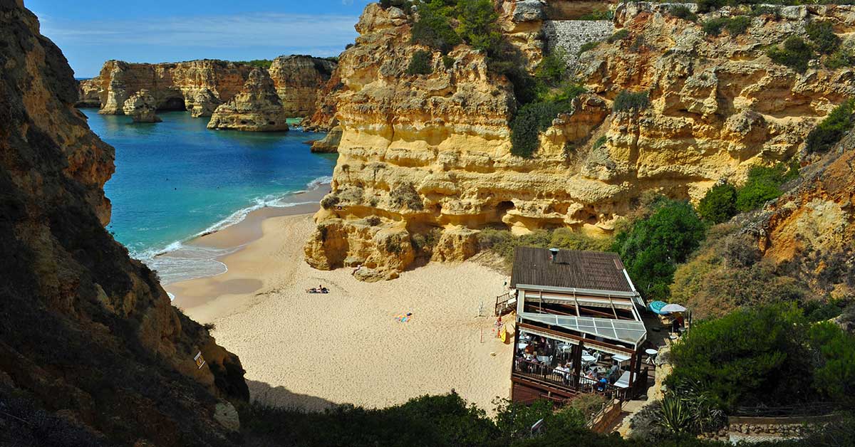 Beach wedding in the Algarve Portugal – ceremony beside golden limestone cliffs